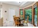 Breakfast nook with a round table, four chairs, and scenic outdoor views at 112 Hidden Bluff Ln, Cary, NC 27513