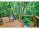 Secluded deck with chairs overlooks the trees and lush greenery at 112 Hidden Bluff Ln, Cary, NC 27513
