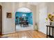 Open dining room with hardwood flooring, an archway, a dining table, and beautiful wall art at 112 Hidden Bluff Ln, Cary, NC 27513