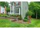 Charming two-story home with landscaped yard and stone steps to the front entrance at 112 Hidden Bluff Ln, Cary, NC 27513