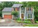 Traditional two-story home with two car garage, beautiful shutters and landscaped front yard at 112 Hidden Bluff Ln, Cary, NC 27513