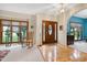 Welcoming foyer with hardwood floors and a beautiful front door leading into a brightly lit living room with large windows at 112 Hidden Bluff Ln, Cary, NC 27513