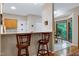 Kitchen view highlighting granite countertop bar, stools, and breakfast nook at 112 Hidden Bluff Ln, Cary, NC 27513
