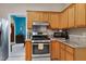 Kitchen view showcasing stainless steel appliances, tile floor, and dining room at 112 Hidden Bluff Ln, Cary, NC 27513