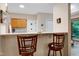 Bright kitchen view featuring granite countertops and seating at the bar at 112 Hidden Bluff Ln, Cary, NC 27513