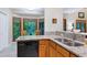Kitchen featuring granite counters, wood cabinets and stainless steel sink and dishwasher at 112 Hidden Bluff Ln, Cary, NC 27513