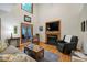Comfortable living room boasting a cozy fireplace with built-in TV, plush seating, and natural light from the window at 112 Hidden Bluff Ln, Cary, NC 27513