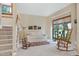 Bright living room with a staircase, large windows, a sofa, and carpet flooring at 112 Hidden Bluff Ln, Cary, NC 27513