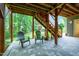 Under-deck patio offers outdoor seating and views of the wooded backyard at 112 Hidden Bluff Ln, Cary, NC 27513