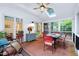 Charming sun room with lots of windows, skylight, and a ceiling fan, perfect for relaxation and dining at 112 Hidden Bluff Ln, Cary, NC 27513