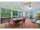 Sunroom featuring a vaulted ceiling, lots of natural light, a ceiling fan, and a table with chairs at 112 Hidden Bluff Ln, Cary, NC 27513