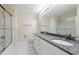 This bathroom has a large mirror, double sinks with granite countertops, and a glass door shower at 115 Spring Branch Dr, Four Oaks, NC 27524