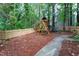 Backyard playground area with a wood fence and a charming green surroundings offers Gathering fun at 11816 Stannary Pl, Raleigh, NC 27613