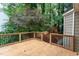 Spacious wooden deck overlooks a lush backyard with mature trees and a playset at 11816 Stannary Pl, Raleigh, NC 27613