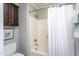Cozy bathroom featuring a shower-tub combo with a curtain and a dark wood cabinet at 11816 Stannary Pl, Raleigh, NC 27613