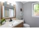 Bright bathroom with a single vanity, granite countertop, and a large window at 11816 Stannary Pl, Raleigh, NC 27613