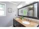 Bathroom featuring double sinks, granite countertops, and a large framed mirror at 11816 Stannary Pl, Raleigh, NC 27613