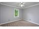 Comfortable bedroom with neutral carpet, a ceiling fan, and a bright window at 11816 Stannary Pl, Raleigh, NC 27613