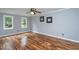 Spacious bedroom with hardwood floors, ceiling fan, and ample natural light at 11816 Stannary Pl, Raleigh, NC 27613