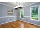 Dining room with hardwood floors, natural light and modern light fixture at 11816 Stannary Pl, Raleigh, NC 27613