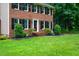 Close-up of a brick home with manicured landscaping and a green lawn at 11816 Stannary Pl, Raleigh, NC 27613