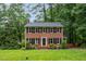 Charming brick two-story home with black shutters and a well-manicured lawn at 11816 Stannary Pl, Raleigh, NC 27613