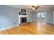 Spacious living room with hardwood floors, fireplace, and natural light at 11816 Stannary Pl, Raleigh, NC 27613