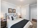 Bedroom with blue accents featuring a comfortable queen bed with white and patterned pillows and bedside tables at 1205 Cosmic Dr, Durham, NC 27703