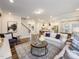 Open-concept living space with kitchen, stairs, large rug, and a comfortable seating area at 1205 Cosmic Dr, Durham, NC 27703