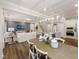 Open-concept living space with a dining area, kitchen, and a cozy seating area with a TV at 1205 Cosmic Dr, Durham, NC 27703
