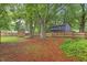 Back yard featuring mature trees, wood privacy fence, storage shed, and a partial view of the home at 12449 W Pamlico St, Middlesex, NC 27557