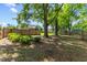 Large, shady back yard featuring a privacy fence and mature trees in a tranquil setting at 12449 W Pamlico St, Middlesex, NC 27557