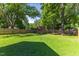 Spacious backyard featuring a privacy fence, mature trees and outbuilding at 12449 W Pamlico St, Middlesex, NC 27557