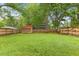 Spacious backyard featuring a privacy fence, mature trees and outbuilding at 12449 W Pamlico St, Middlesex, NC 27557