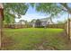 View of the backyard featuring a privacy fence, green lawn, and rear elevation of home at 12449 W Pamlico St, Middlesex, NC 27557