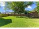 Spacious backyard featuring a privacy fence, mature trees and outbuilding at 12449 W Pamlico St, Middlesex, NC 27557