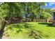 Spacious backyard featuring a privacy fence, mature trees and outbuilding at 12449 W Pamlico St, Middlesex, NC 27557