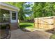 Backyard with screened-in porch, stairs, a wooden fence, and a gate at 12449 W Pamlico St, Middlesex, NC 27557