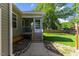 Backyard with screened-in porch, wood steps, and well-manicured lawn at 12449 W Pamlico St, Middlesex, NC 27557