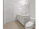 Bright bathroom features a dual sink vanity with large framed mirror and a toilet at 12449 W Pamlico St, Middlesex, NC 27557