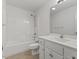 Bathroom with white vanity, framed mirror and tub-shower combo at 12449 W Pamlico St, Middlesex, NC 27557