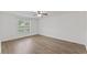 Bright bedroom features neutral walls, hardwood floors, and a ceiling fan with a light at 12449 W Pamlico St, Middlesex, NC 27557
