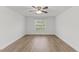 Bright bedroom features neutral walls, hardwood floors, and a ceiling fan with a light at 12449 W Pamlico St, Middlesex, NC 27557