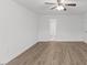 Bright bedroom features neutral walls, hardwood floors, ceiling fan with a light and adjoined bathroom at 12449 W Pamlico St, Middlesex, NC 27557
