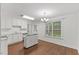 Well-lit kitchen with white cabinets, island, and stainless steel appliances at 12449 W Pamlico St, Middlesex, NC 27557