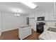 Open concept with island, black appliances, and white cabinets at 12449 W Pamlico St, Middlesex, NC 27557