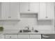 Kitchen sink and faucet with white subway tile backsplash and light marbled countertops at 12449 W Pamlico St, Middlesex, NC 27557