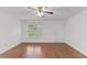 Hardwood floors, white walls, ceiling fan, and a window make this living room a bright space at 12449 W Pamlico St, Middlesex, NC 27557