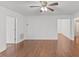 Open concept living room with hardwood floors, white walls, and a ceiling fan at 12449 W Pamlico St, Middlesex, NC 27557