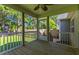 Screened porch with ceiling fan and view of the backyard at 12449 W Pamlico St, Middlesex, NC 27557